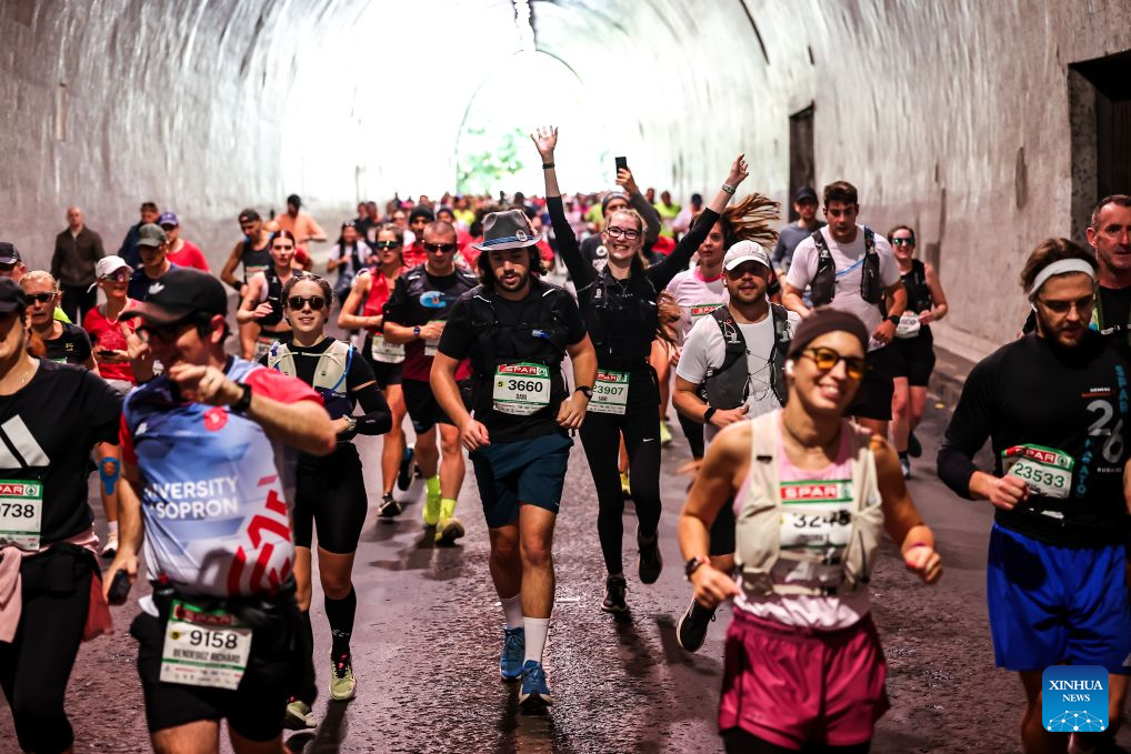 Runners pass through a tunnel during the 41st SPAR Budapest Marathon in Budapest, Hungary, Oct. 11, 2026. (Photo by David Balogh/Xinhua)