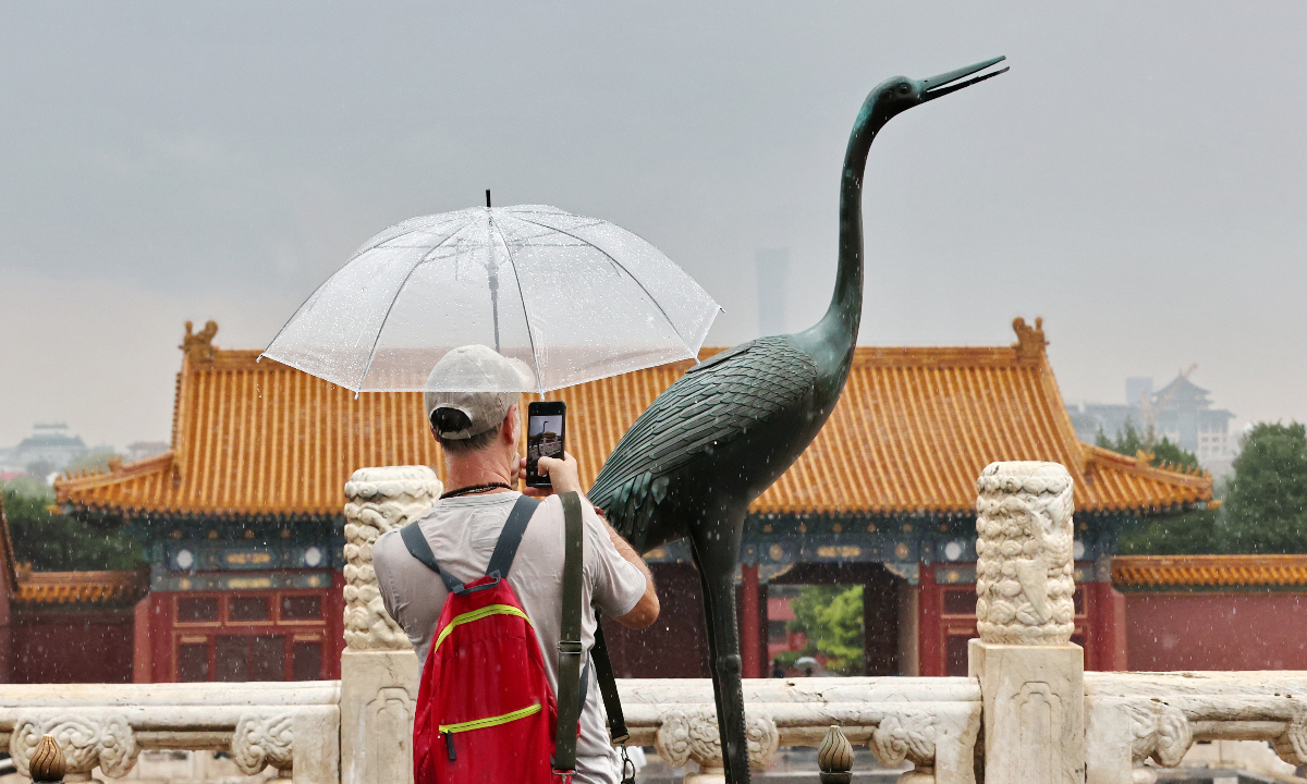 Visitors toured the Palace Museum during heavy rain after a sudden downpour in Beijing on August 2, 2026. Photo: VCG