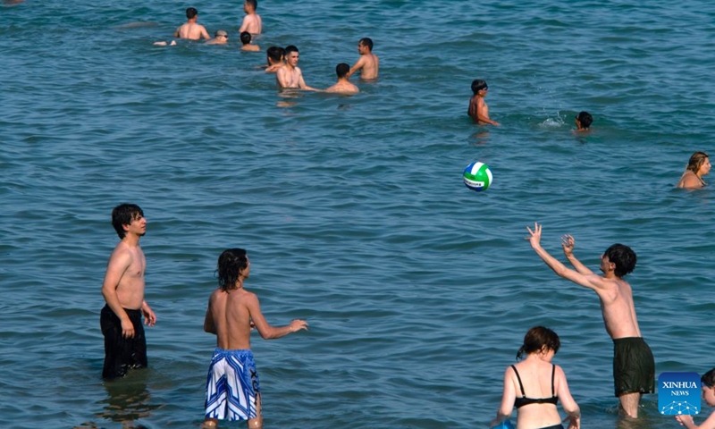 People have fun in the Caspian Sea in Baku, Azerbaijan, June 20, 2026. The temperature in Baku hit 33 degrees Celsius in the afternoon on June 20. Shikhov Beach in Baku attracted numerous locals and tourists for swimming and leisure. (Xinhua/Chen Junfeng)