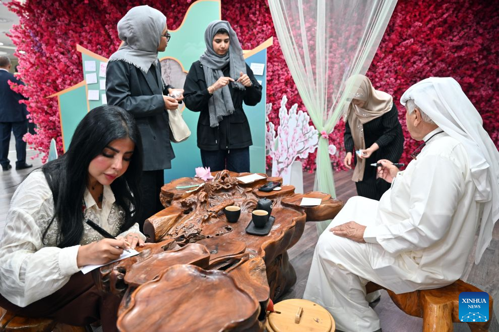 People participate in the Chinese & Kuwaiti Tea Art and Treats Tasting event at the China Cultural Center in Kuwait in Hawalli Governorate, Kuwait, Aug. 23, 2026. (Photo by Asad/Xinhua)