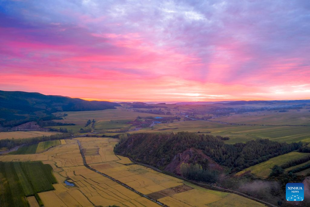 An aerial drone photo taken on Sept. 25, 2026 shows a view of the morning glow over Hailin City, northeast China's Heilongjiang Province. In autumn, Heilongjiang Province is filled with vibrant colors. Mountains, forests and waters form a picturesque landscape, showcasing the beauty of autumn in northeastern China. (Photo by Wang Baoxun/Xinhua)