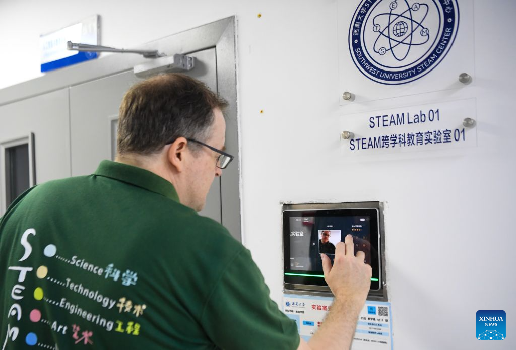 Francis Stonier goes into a lab of the STEAM Interdisciplinary International Education Center in Southwest University in southwest China's Chongqing Municipality, Sept. 14, 2026. (Xinhua/Tang Yi)