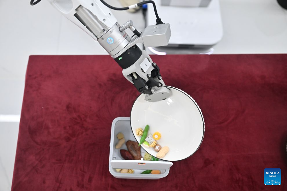 A robot is seen during a training at a robot data collection center of Chinese e-commerce giant JD.com in Suqian, east China's Jiangsu Province, Aug. 24, 2026. In operation since October 2025, JD.com's robot data collection center is a provincial-level embodied intelligent robot data collection center in east China's Jiangsu Province. The facility enhances the data collection scenarios in terms of physical fidelity, generalization ability, and interaction quality. It upgrades the data collection environment to a real physical scene, transforming the data collection center from a static sample library into a training ground for embodied intelligent robots. (Xinhua/Ji Chunpeng)