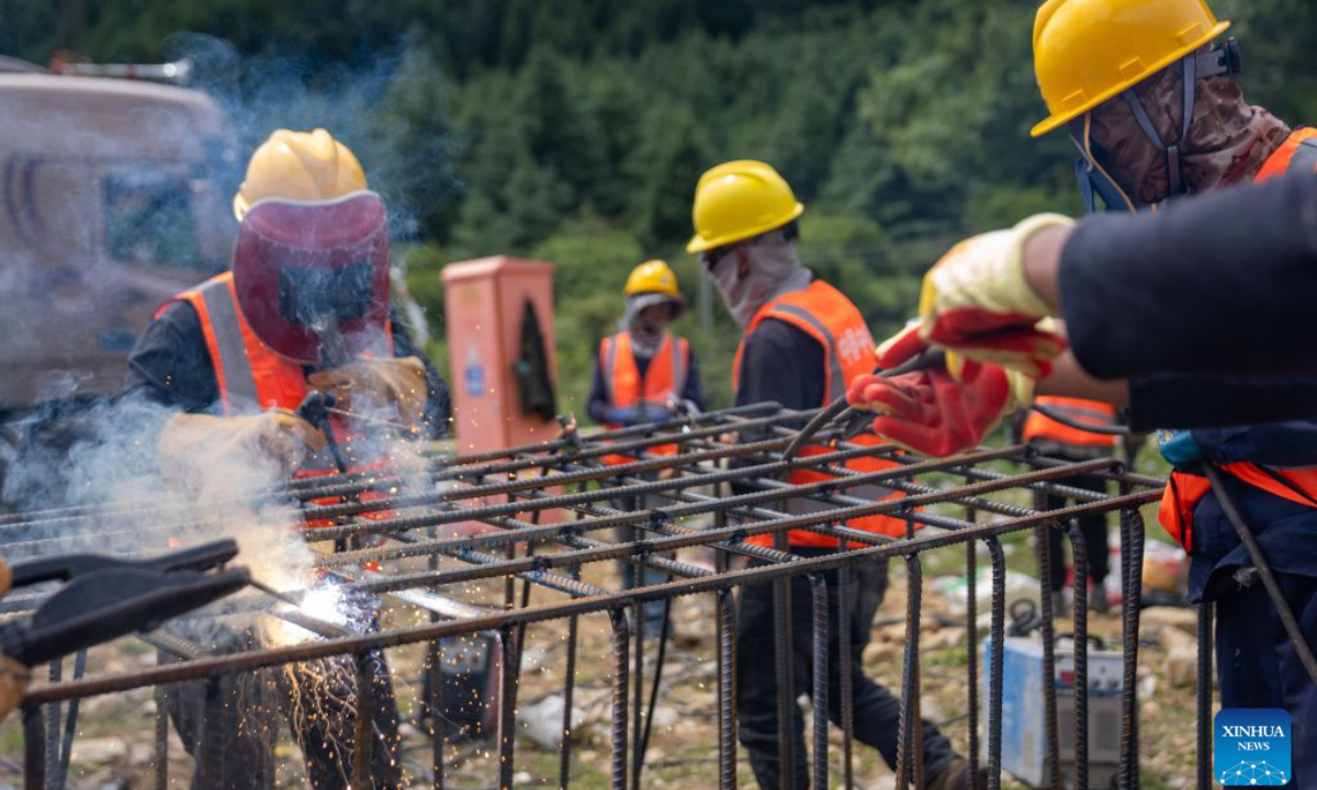 Workers from China Railway Group Limited weld steel-reinforced gabion baskets at a temporary processing site in Gyirong County, southwest China's Xizang Autonomous Region, Aug. 30, 2026. Workers from China Railway Group Limited stepped up efforts on Sunday to make steel-reinforced gabion baskets to support the restoration of road access to mudslide-hit areas in Gyirong County for rescue operations. (Xinhua/Tenzing Nima Qadhup)