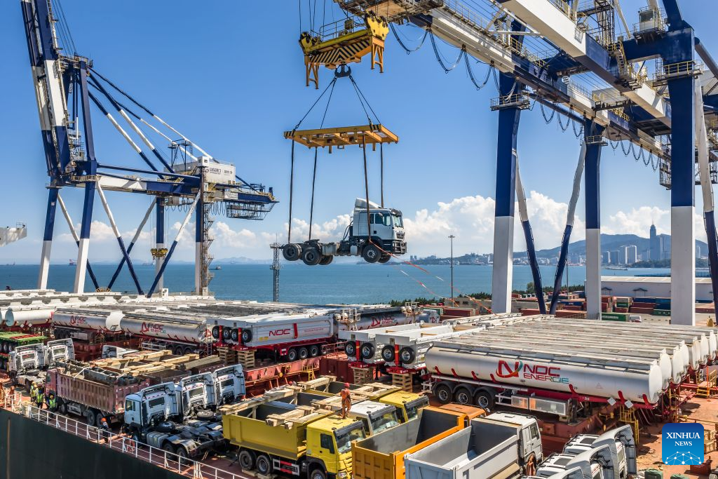 A drone photo taken on Aug. 16, 2026 shows China-produced trucks bound for Ghana being loaded onto a vessel at Yantai Port in east China's Shandong Province. Yantai Port's general cargo shipment volume to Africa has exceeded 6 million tonnes since the beginning of this year, a year-on-year increase of 66.1 percent. (Photo by Zhang Chao/Xinhua)