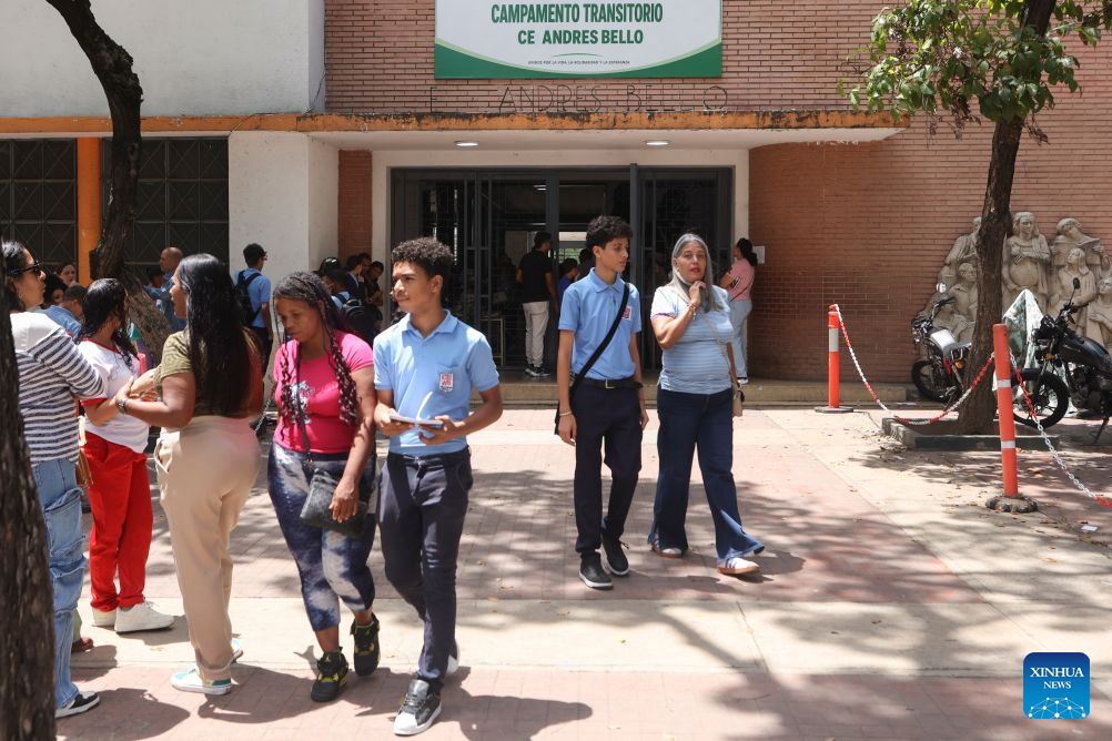 Students are pictured near a school, in Caracas, Venezuela, Sept. 14, 2026. More than 6 million Venezuelan students began the new school year on Monday, including those in La Guaira state in the country's north, which was hard hit by earthquake. (Photo by Marcos Salgado/Xinhua)