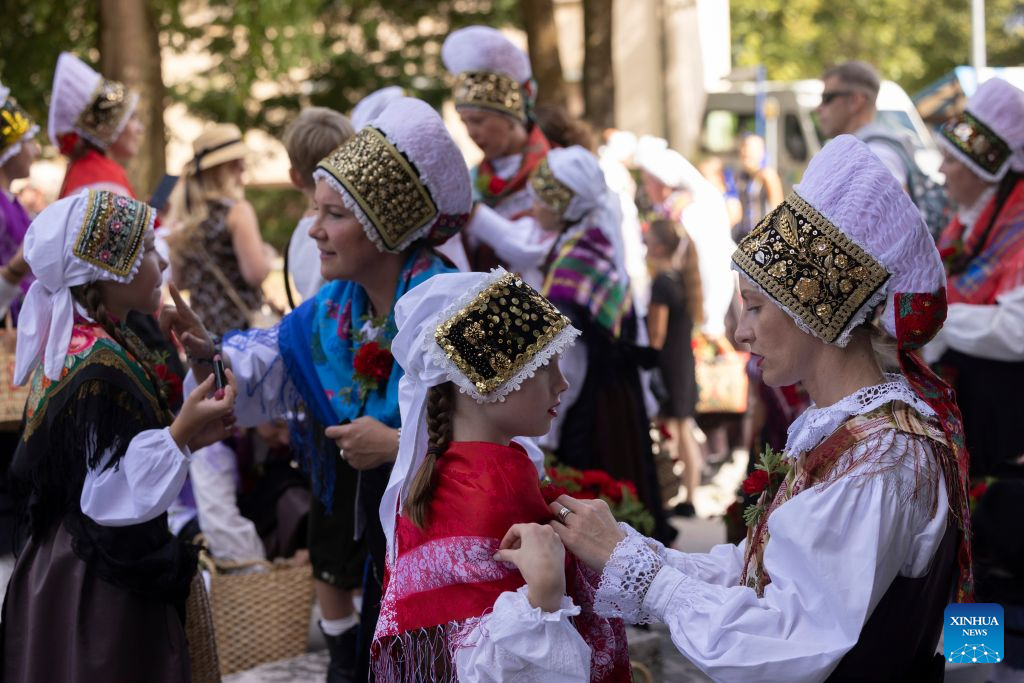 Women in Slovenian traditional costumes prepare before the parade of the 53rd National Costumes and Clothing Heritage Day in Kamnik, Slovenia, Sept. 13, 2026. The 53rd National Costumes and Clothing Heritage Day ended Sunday in Kamnik with a traditional parade, during which about 2,000 participants dressed in national costumes walked through the center of Kamnik. (Photo by Zeljko Stevanic/Xinhua)