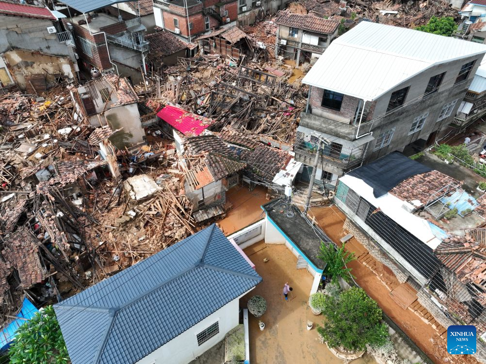 A drone photo taken on Sept. 5, 2026 shows a villager clearing mud from a yard in Xiagao Village of Huating Town in Putian, southeast China's Fujian Province. As heavy rainfall caused by Typhoon Saudel in Putian concluded on Saturday, floodwaters gradually receded in inundated areas of this city. Local authorities have since shifted to post-disaster recovery, undertaking tasks including water and power restoration, sanitation and disinfection, as well as the resettlement of affected residents. (Xinhua/Jiang Kehong)