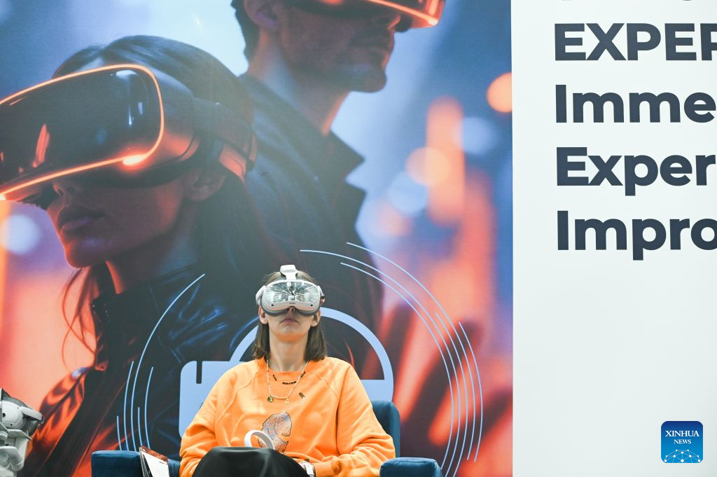 A visitor tries a virtual reality headset at the World of AI and Big Data Expo in Warsaw, Poland, Sept. 22, 2026. Held from Sept. 22 to 24, the World of AI and Big Data Expo in Warsaw focuses on artificial intelligence, big data and related digital technologies, showcasing innovations in AI applications, data management, robotics and intelligent automation. (Photo by Aleksy Witwicki/Xinhua)
