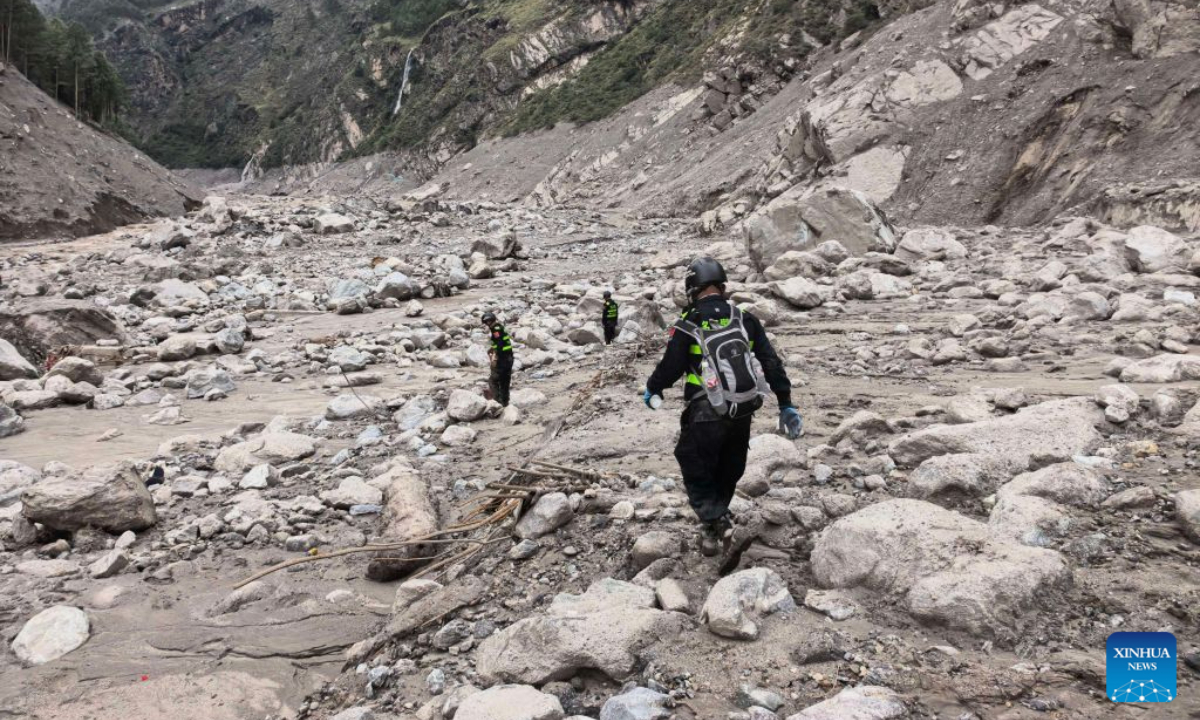 Rescuers carry out search and rescue operations at the mudslide-hit area in Gyirong County, southwest China's Xizang Autonomous Region, Aug. 30, 2026. Rescuers are racing against time and the odds in search of survivors after a devastating mudslide, triggered by an ice-rock avalanche in Nepal, hit the border port of Gyirong in southwest China's Xizang Autonomous Region. (Photo by Mu Dan/Xinhua)