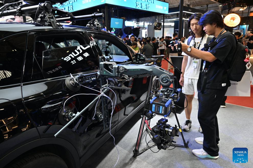 Visitors try a remote gimbal control product during the 33rd Beijing International Radio, TV & Film Exhibition (BIRTV 2026) in Beijing, capital of China, Aug. 20, 2026. The ongoing 33rd Beijing International Radio, TV & Film Exhibition is held here from Aug. 19 to Aug. 22. (Xinhua/Zheng Huansong)