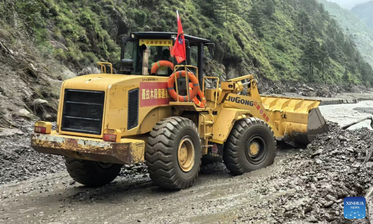 A rescue vehicle clears a road leading to Gyirong Port in Xigaze, southwest China's Xizang Autonomous Region, Aug. 27, 2026. After a mudslide struck Gyirong Port in Gyirong County on Wednesday morning, local traffic authorities swiftly carried out emergency rescue and road clearance operations on the affected section of national highway G216 leading to the Gyirong Port. As of 6:00 p.m. on Thursday, approximately 800 meters of the affected section had been cleared and reopened. (Xinhua)