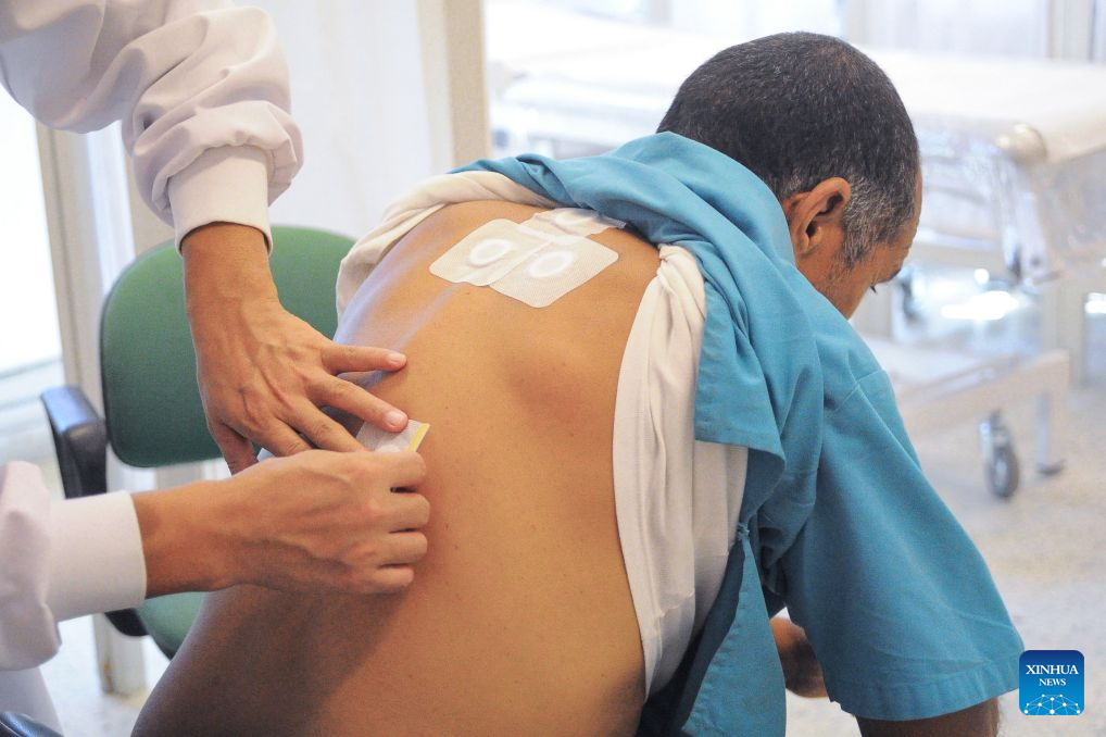 A doctor administers Sanfutie, or Sanfu plaster, a centuries-old traditional Chinese medicine therapy, to a patient in Tunis, Tunisia, Aug. 14, 2026. The 30th Chinese medical team to Tunisia conducted Sanfutie treatments for the Tunisian people on Friday. (Photo by Adel Ezzine/Xinhua)