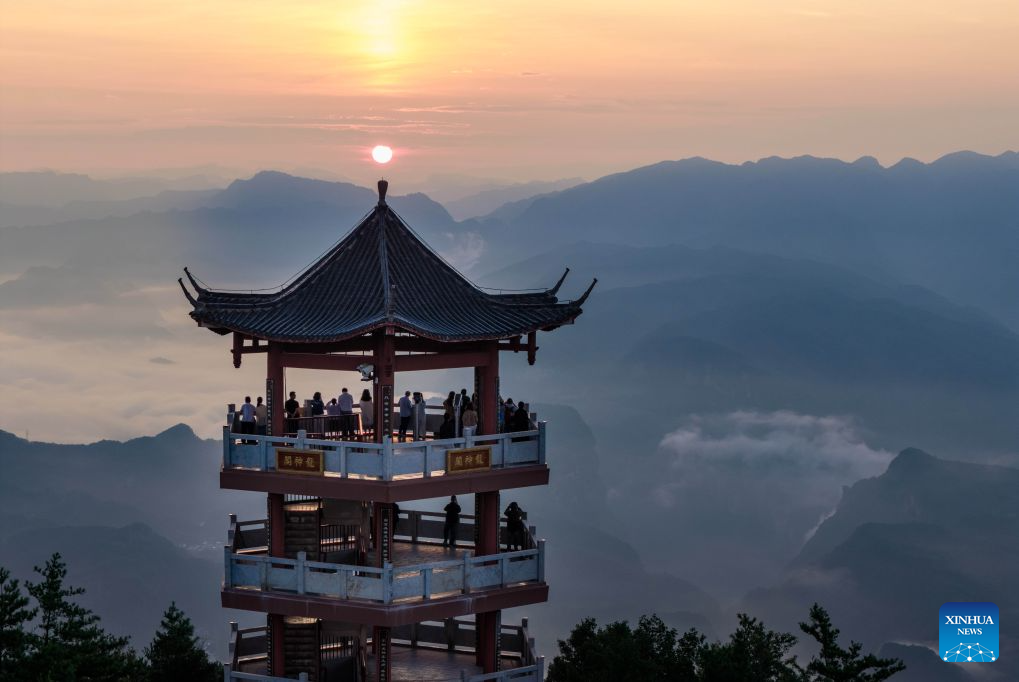 An aerial drone photo taken on Aug. 23, 2026 shows tourists enjoying sunrise scenery in Zengjiashan scenic spot of Guangyuan City, southwest China's Sichuan Province. Zengjiashan, a summer getaway with an average elevation of 1,300 meters and summer temperatures of around 23 degrees centigrade, is developing tourism by making the most of its cool climate, attracting visitors from surrounding areas. (Xinhua/Jiang Hongjing)