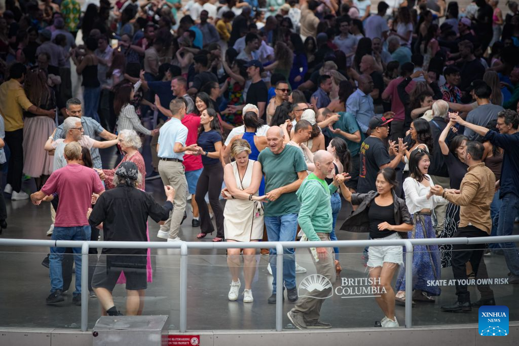 People participate in the Sunday Afternoon Salsa and Bachata event at Robson Square in Vancouver, British Columbia, Canada, on Aug. 30, 2026. Hundreds of people of different ages took part in the annual Sunday Afternoon Salsa and Bachata event here on Sunday. The outdoor event brought together dance enthusiasts and beginners to enjoy Latin-style music and dancing. (Photo by Liang Sen/Xinhua)