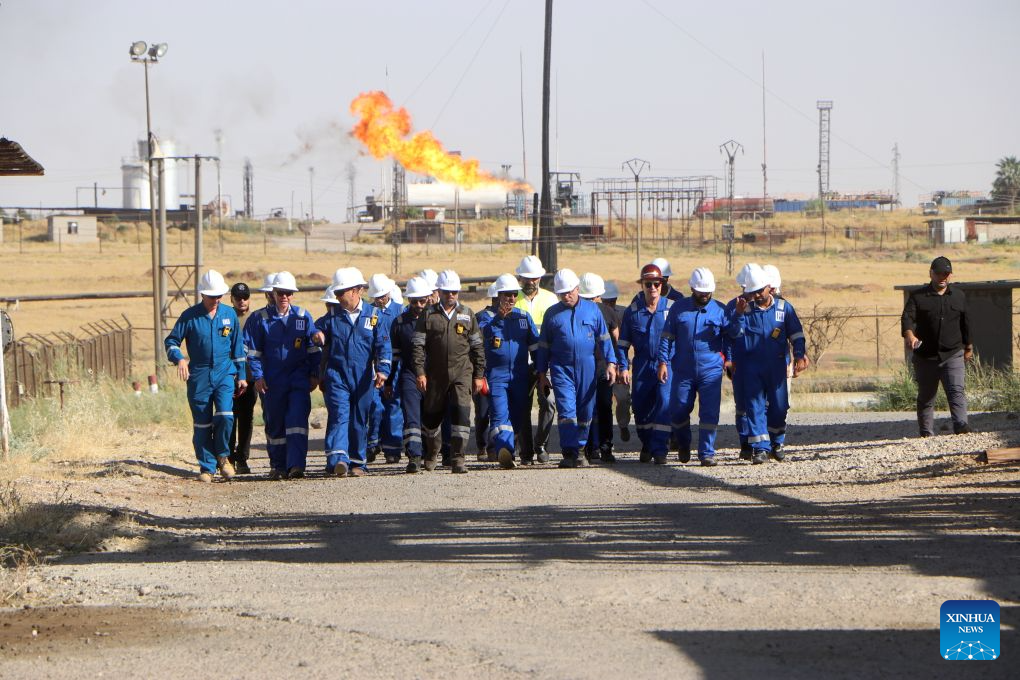 Officials and engineers tour the Rmelan oil fields in Hasakah province, northeastern Syria, Aug. 4, 2026. Officials said rehabilitation projects are expected to modernize production facilities and gradually raise output at the country's largest oil fields. (Str/Xinhua)