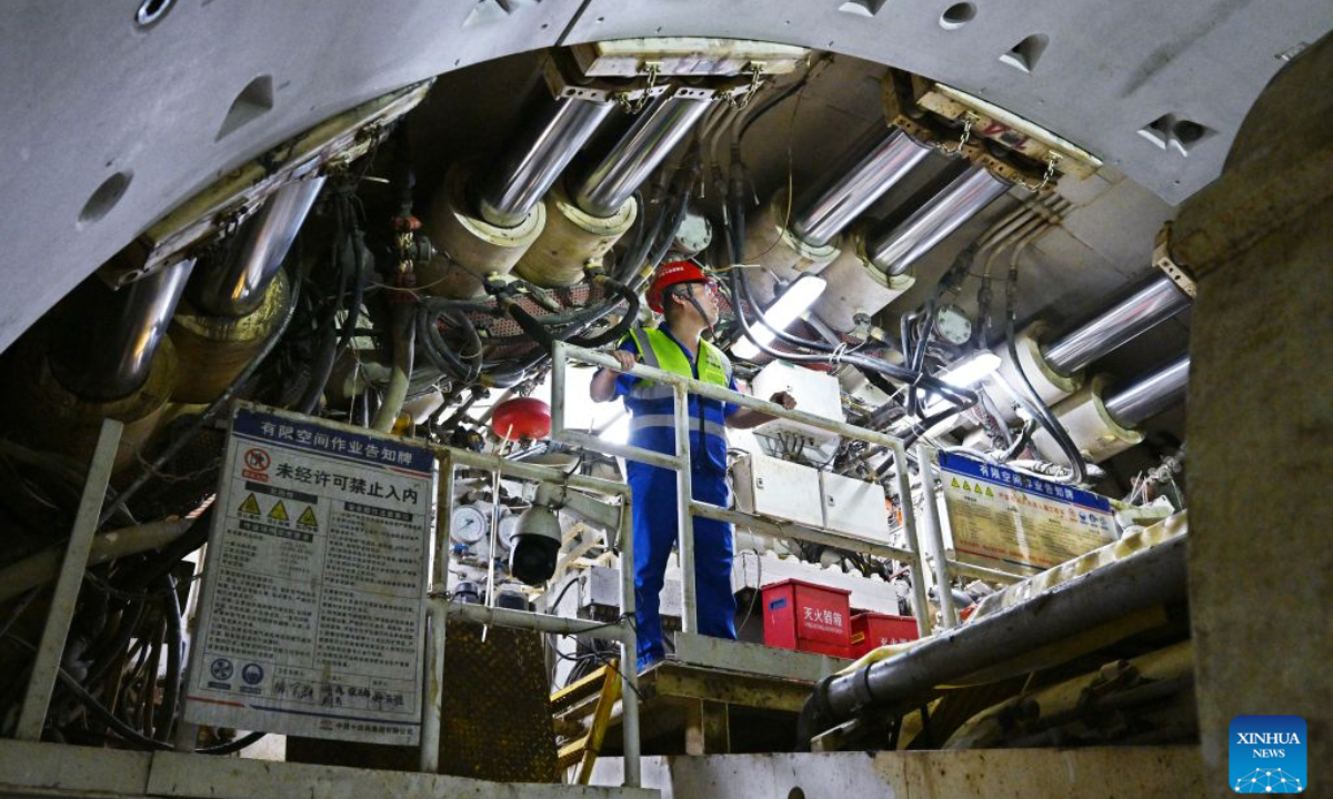 A constructor makes a safety inspection at the construction site of Qingdao Jiaozhou Bay Second Tunnel in Qingdao, east China's Shandong Province, Oct. 2, 2026. China's longest undersea highway tunnel completed all shield-driven excavation work on Friday as a shield machine reached its designated position at a depth of 105 meters beneath the sea surface in Jiaozhou Bay, eastern China's Shandong Province, according to China Railway Construction Corporation Limited.
The Qingdao Jiaozhou Bay Second Tunnel will connect Qingdao's main urban area with the Qingdao West Coast New Area. The latter is a national-level new area. The 17.48-km project includes a 14.37-km main tunnel section, featuring two main tunnels and a middle service tunnel, with three lanes in each direction and a design speed of 80 km per hour. (Xinhua/Li Ziheng)