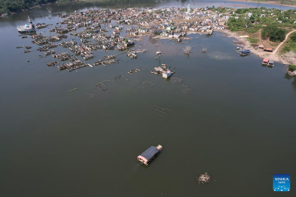 An aerial drone photo taken on July 28, 2026 shows remains of houses re-emerging as the reservoir's water level drops in Lebak regency, Banten province, Indonesia. Due to the impact of El Nino, the dry season in Indonesia has been more intense and prolonged this year, with heightened risks of wildfires and droughts. (Xinhua/Veri Sanovri)