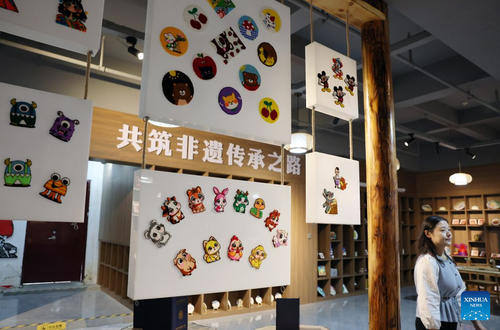 Duoxiu embroidery works are displayed at a study tour base in Yuanzhou District, Guyuan City of northwest China's Ningxia Hui Autonomous Region, Sept. 21, 2026. Yuanzhou District in Guyuan City has developed an integrated model combining intangible cultural heritage, original design and e-commerce, encouraging local businesses to develop original Duoxiu embroidery patterns and expand handicraft markets. The district has established 12 community handicraft workshops, creating jobs for more than 3,600 people and turning traditional skills into economic opportunities. (Xinhua/Liu Yun)