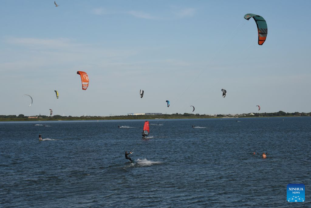 Surfing enthusiasts surf on the Ijsselmeer lake near Kornwerderzand in Friesland Province, the Netherlands, Aug. 2, 2026. (Xinhua/Shao Haijun)