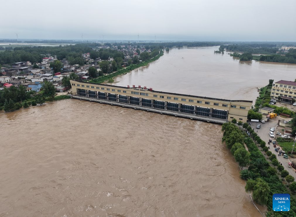 An aerial drone photo taken on Aug. 13, 2026 shows a flood discharge scene at the Nihewa flood storage and detention area in Wuyang County of Luohe City, central China's Henan Province. Affected by Typhoon Dolphin, the 13th typhoon of the year, the Shaying River has recorded a flow rate exceeding 3,000 cubic meters per second in its Luohe section, while the water level continues to rise. In accordance with relevant contingency plans, Henan Province activated the Nihewa flood storage and detention area on Thursday. (Xinhua/Hao Yuan)