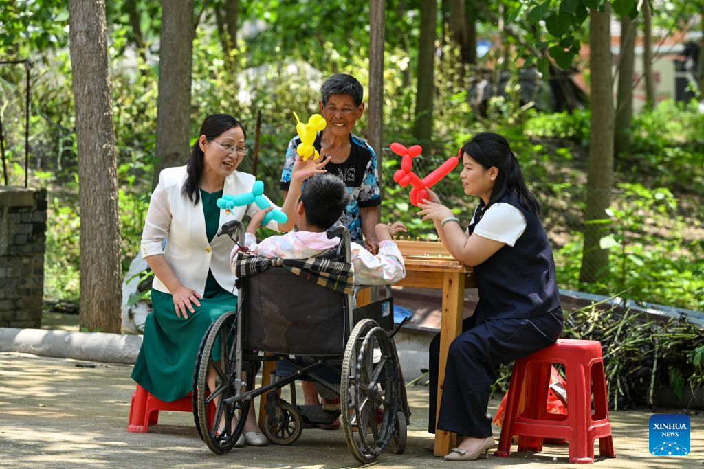 Gao Chunying (1st L) and Kong Zhongqing (1st R), teachers of Jinhu Special Education School, teach a student the concept of color in Jinhu County of Huai'an, east China's Jiangsu Province, May 28, 2026.

In 2016, Jinhu Special Education School launched a home-based teaching program for children with severe disabilities. Over the past decade, teachers involved in the program have traveled nearly 80,000 kilometers across the county to teach students in their homes.

For each child, the teachers develop an individualized education plan covering cognitive development, daily living skills and rehabilitation training, while also providing families with parenting and caregiving guidance. Through patience and consistent efforts, they have gradually earned the children's trust and helped many of them make notable progress.

Over the past 10 years, eight children have successfully made the transition from home-based education to attending school. A total of 42 children with severe disabilities have received systematic education and rehabilitation services. (Photo by Liang Debin/Xinhua)
