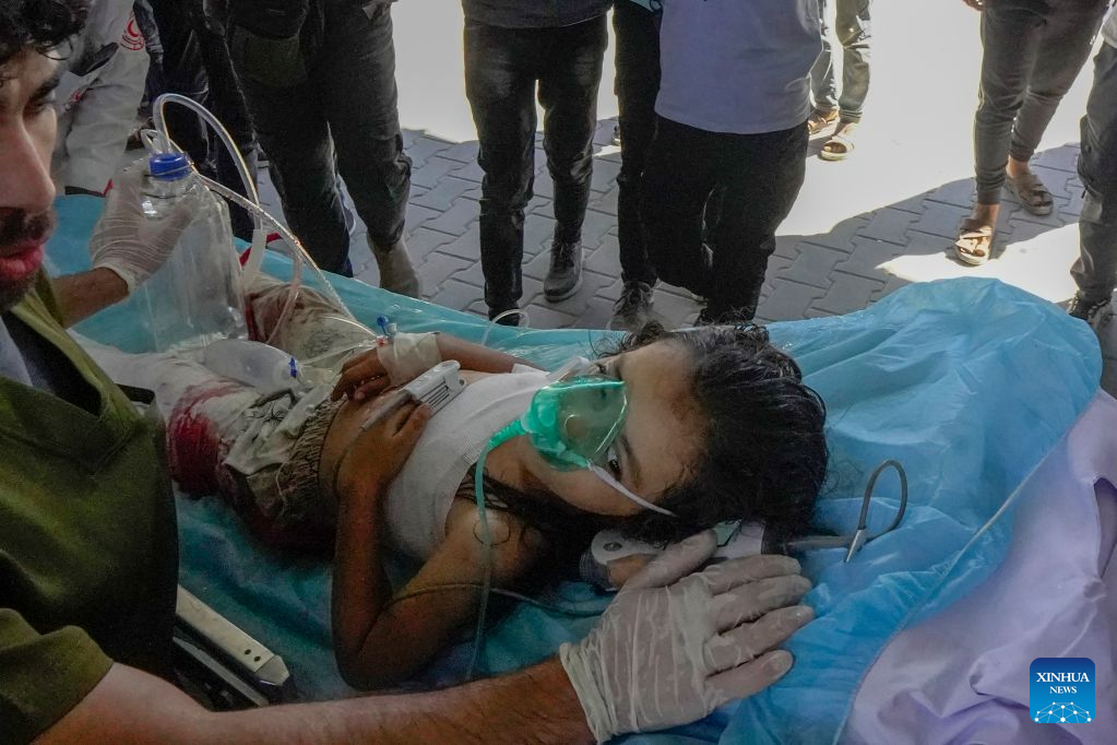 An injured child is seen after being evacuated from the site of an Israeli airstrike, at Al-Shifa hospital, in Gaza City, on Aug. 19, 2026. At least nine Palestinians, including a woman, were killed Wednesday in an Israeli airstrike targeting a Hamas-run municipal police headquarters in central Gaza City, according to Palestinian sources.
Sources and witnesses said the airstrike caused a large explosion and scattered shrapnel around the headquarters, which is surrounded by tents housing displaced people. (Photo by Rizek Abdeljawad/Xinhua)