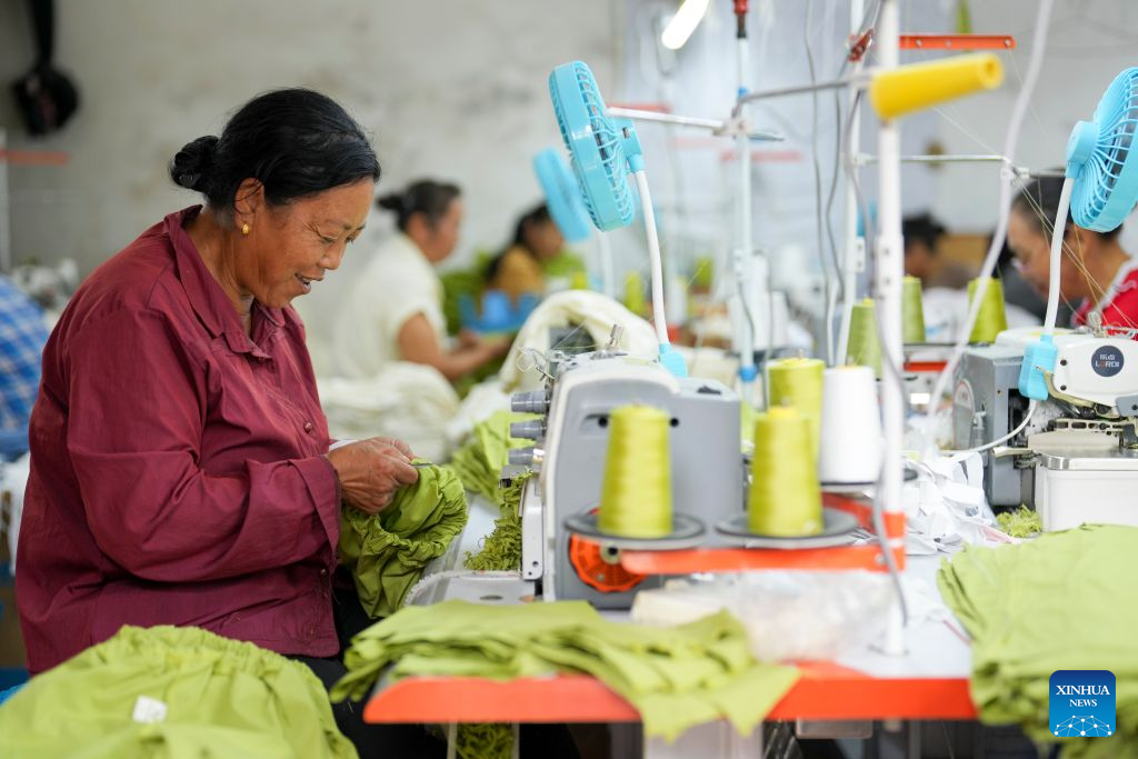 Farmers work at a clothing factory in Chonghe Village of Anwen Town in Qijiang District, southwest China's Chongqing, Sept. 15, 2026.
After the Zunyi Meeting in 1935, more than 8,000 Red Army soldiers were stationed overnight in Qijiang, creating a valuable opportunity for the first crossing of the Chishui River during the Long March.
Leveraging its rich red history, Qijiang is committed to developing red tourism, while steadily advancing rural revitalization by building vegetable, breeding, and clothing industries. (Xinhua/Liu Chan)