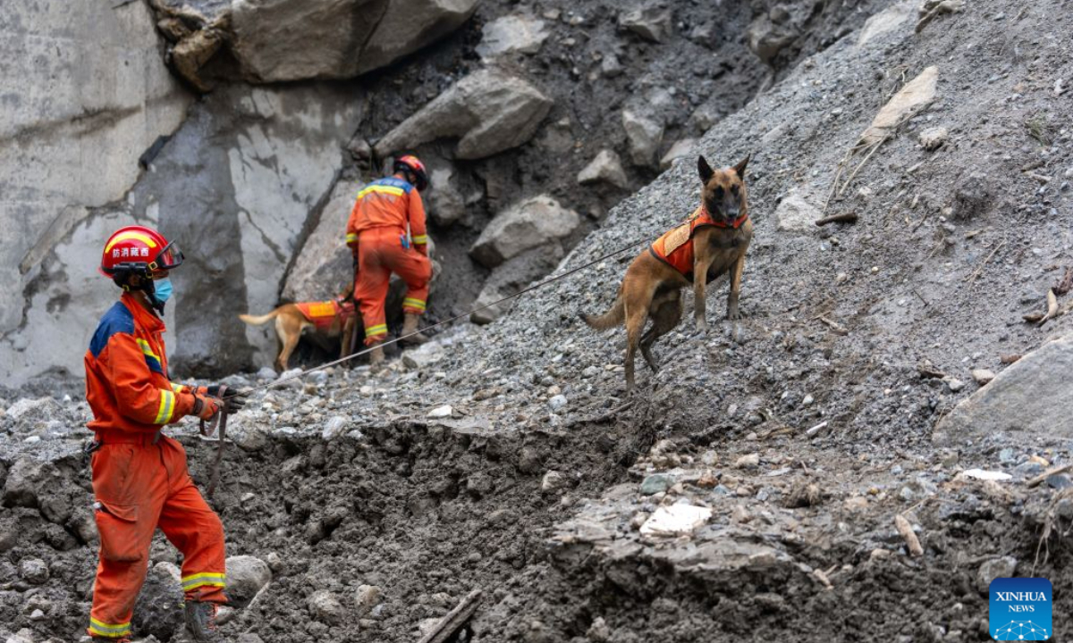 Rescuers and sniffer dogs search for the missing at the mudslide-hit area in Gyirong County, southwest China's Xizang Autonomous Region, Aug. 30, 2026. Rescuers are racing against time and the odds in search of survivors after a devastating mudslide, triggered by an ice-rock avalanche in Nepal, hit the border port of Gyirong in southwest China's Xizang Autonomous Region. (Xinhua/Tenzing Nima Qadhup)