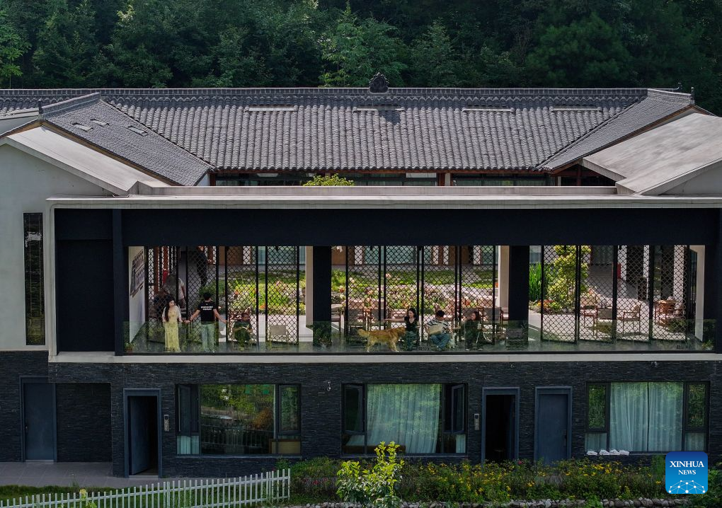 A drone photo taken on Aug. 23, 2026 shows tourists resting at a homestay in Zengjiashan scenic spot of Guangyuan City, southwest China's Sichuan Province. Zengjiashan, a summer getaway with an average elevation of 1,300 meters and summer temperatures of around 23 degrees centigrade, is developing tourism by making the most of its cool climate, attracting visitors from surrounding areas. (Xinhua/Jiang Hongjing)