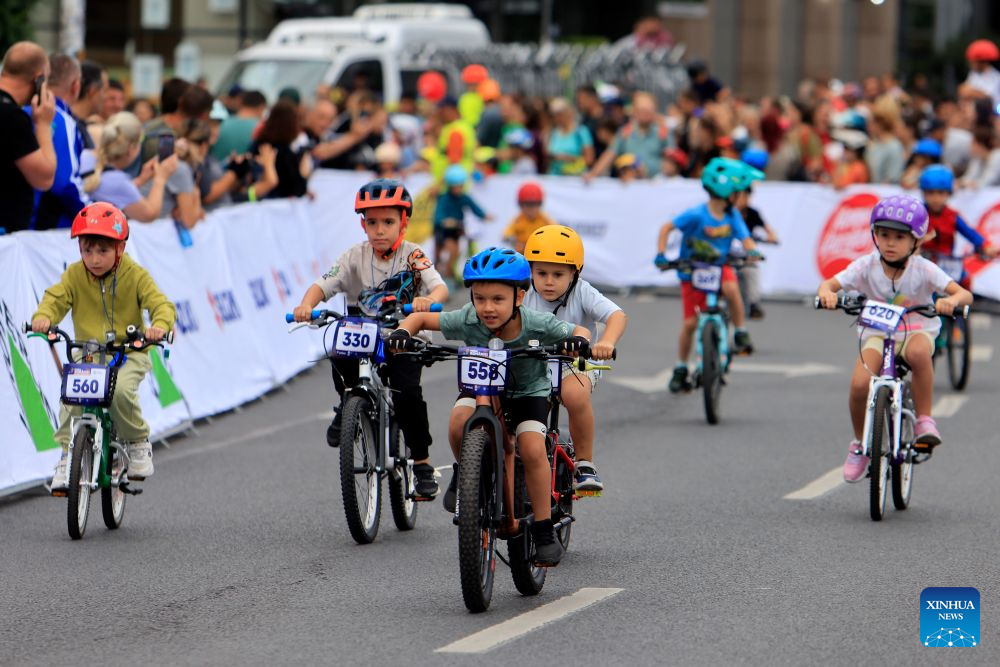 Children compete in the Children's Race after the Tour of Romania cycling race in Bucharest, Romania, Sept. 13, 2026. (Photo by Cristian Cristel/Xinhua)