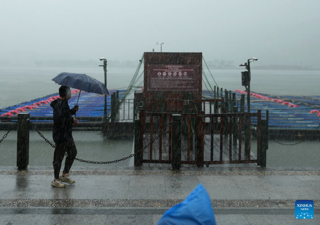 A visitor walks past a dock that is temporarily closed on the West Lake in Hangzhou, east China's Zhejiang Province, Aug. 9, 2026. China's national observatory on Sunday activated a red alert -- the highest level in the country's typhoon warning system -- as Typhoon Dolphin approaches.

Typhoon Dolphin is forecast to make landfall along the country's east coast from Zhoushan in Zhejiang Province to Fuding in Fujian Province, according to the National Meteorological Center (NMC). (Xinhua/Han Chuanhao)