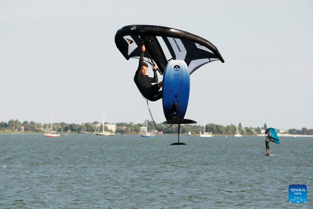 Surfing enthusiasts surf on the Ijsselmeer lake near Kornwerderzand in Friesland Province, the Netherlands, Aug. 2, 2026. (Xinhua/Shao Haijun)