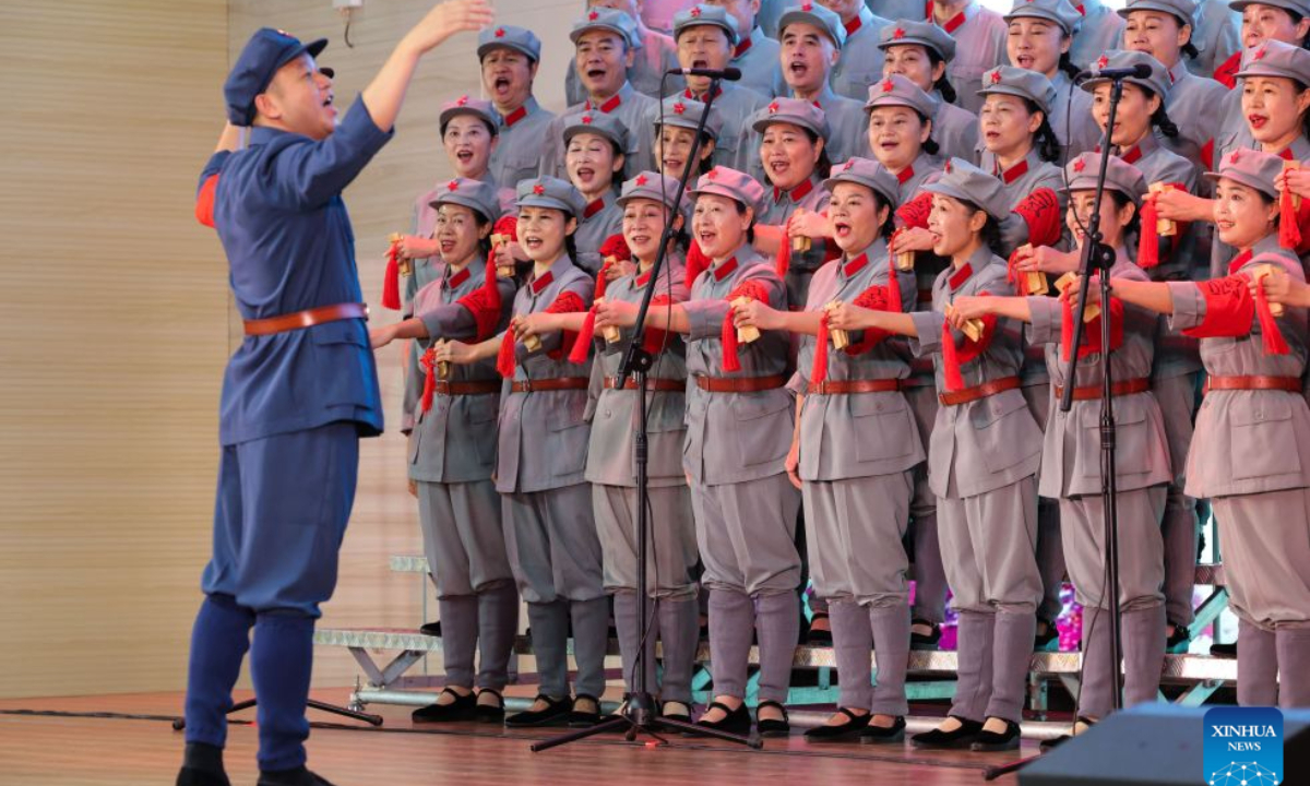 Zou Weimin (1st L), the director of the Long March Origin choir, conducts a performance at a middle school in Yudu County, east China's Jiangxi Province, Sept. 3, 2026. This year marks the 90th anniversary of the victory of the Long March. As one of its important starting points, Yudu County in east China's Jiangxi Province, a place best known as the starting point of the Long March by the Central Red Army, the historic military maneuver in modern Chinese history, has become more than a place of remembrance.
It was from Yudu that more than 80,000 Red Army soldiers crossed the Yudu River and began the Long March in 1934, the roughly 12,500-kilometer trek later described by American journalist Harrison Salisbury as a great human epic.
On the stone tablet in front of the memorial museum of the Central Red Army's departure for the Long March here in Yudu, three Chinese characters meaning Long March Origin are engraved. The Long March Origin not only indicates that this place was the starting point of the important strategic transfer of the Red Army at that time, but also carries the profound understanding of the Long March spirit by the people of Yudu to this day.
You can see the words Long March Origin frequently in Yudu, and the Long March Origin choir is a prominent presence.
In this red revolutionary land of Yudu, almost everyone can share family stories connected to the Red Army's Long March. The Long March Origin choir, established in 2010, is composed of over 100 descendants of Red Army soldiers from all walks of life in the county. Over these years, they have not only performed the Suite of Songs on the Long March in Yudu and across Jiangxi in their spare time, but also carried forward the spirit of the Long March along the Long March route with their songs.
The choir's first performance was staged on June 30, 2011, which was dedicated to the 90th anniversary of the founding of the Communist Party of China. So far the choir has performed over 730 charity performances. We hope that the choir will complete 1,000 performances by the 100th anniversary of the victory of the Long March, said Zou Weimin, the director of the choir. (Xinhua/Wang Jingqiang)