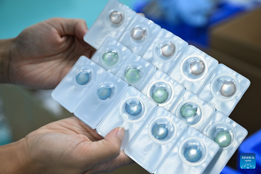 A staff member conducts quality check on contact lenses at a workshop in Fengjie County, southwest China's Chongqing Municipality, Sept. 15, 2026. In recent years, Fengjie County has vigorously developed its eyewear industry, which provided over 3,500 new jobs, with products exported to more than 30 countries and regions. (Xinhua/Chen Cheng)