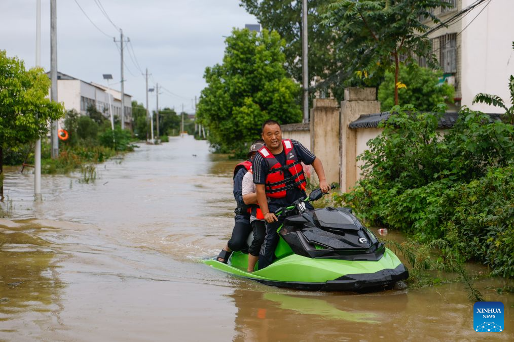 Rescue workers conduct operations using a motorized boat in Nanwang Village of Xiangzhou District, Xiangyang City of central China's Hubei Province, Aug. 12, 2026. Torrential rains and flooding caused by Typhoon Dolphin, the 13th typhoon of the year, have swept vast regions in eastern and central China. Local authorities are exerting all efforts to eradicate potential risks and put people's life back to normal. (Xinhua/Wu Zhizun)