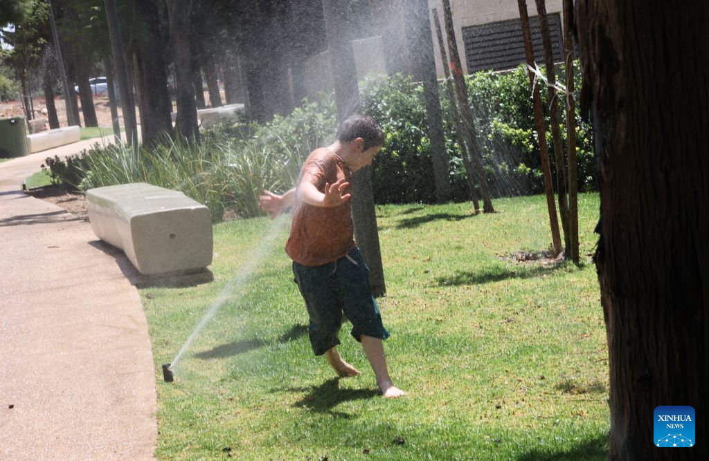 A child cools off during a heatwave at a park in Jerusalem, Aug. 2, 2026. A severe heatwave has swept across Jerusalem in recent days. (Photo by Gil Cohen Magen/Xinhua)