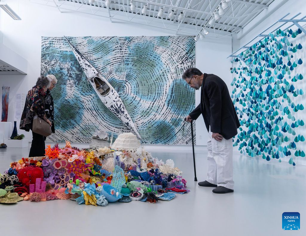Visitors view artworks on display at the World of Threads Festival 2026 in Oakville, Ontario, Canada, on Sept. 28, 2026. Showcasing contemporary fibre and textile art in all forms from around the world, the event will last till Jan. 17, 2027. (Photo by Zou Zheng/Xinhua)