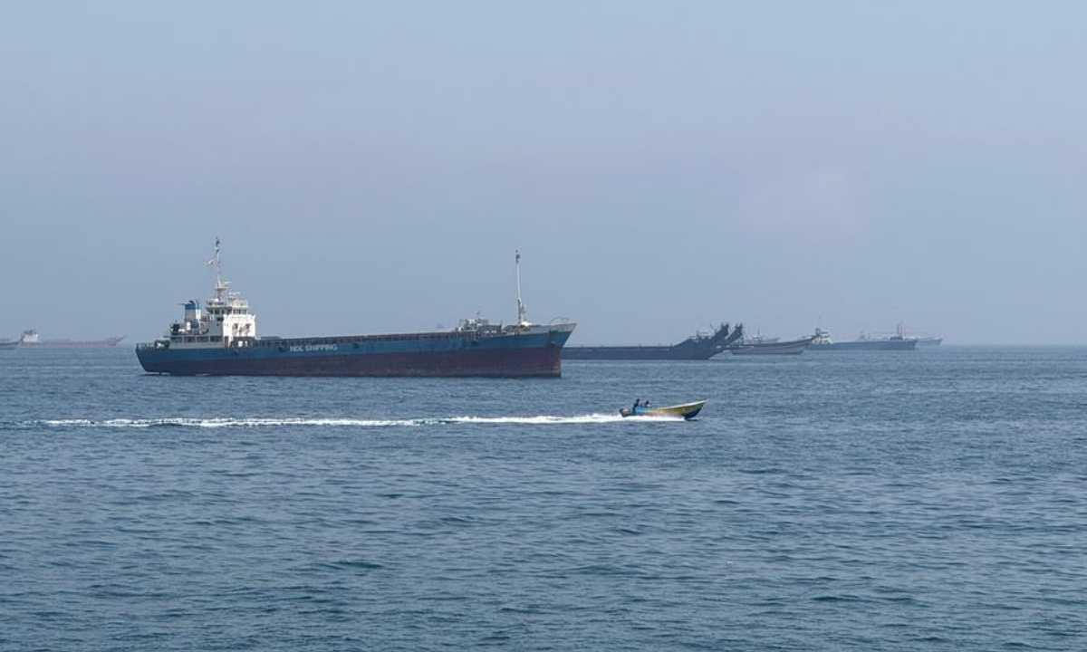 This photo taken with a mobile phone shows merchant vessels stranded in the waters of the Strait of Hormuz, near Khasab, a small town in northern Oman, May 29, 2026. (Xinhua/Wen Xinnian)