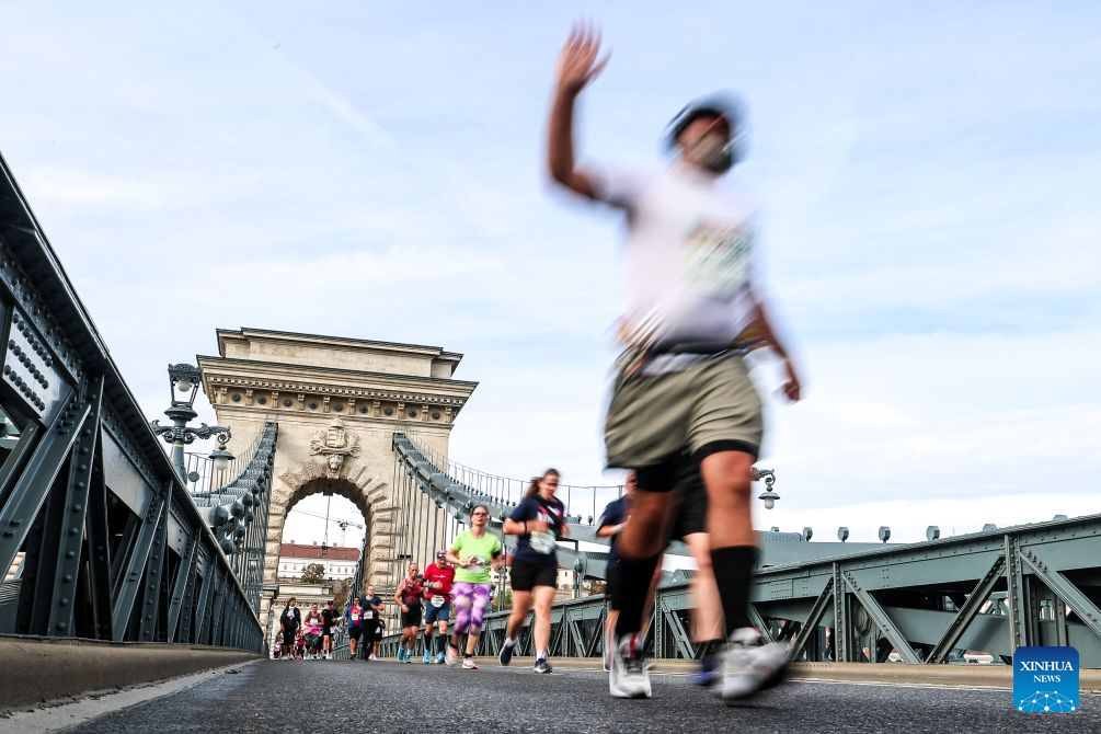 Runners run through the Chain Bridge during the 41st SPAR Budapest Marathon in Budapest, Hungary, Oct. 11, 2026. (Photo by David Balogh/Xinhua)