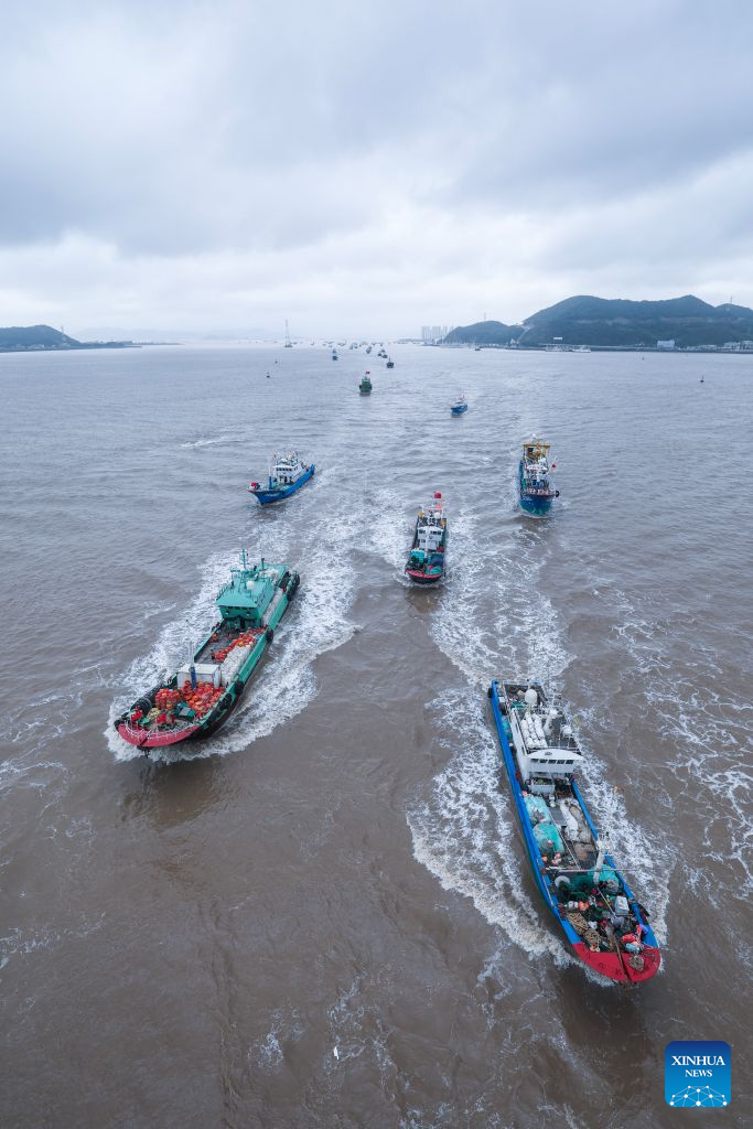 Fishing boats set sail for fishing from Shenjiamen Port in Zhoushan, east China's Zhejiang Province, Aug. 11, 2026. Four types of fishing boats with special permission set sail on Tuesday after a three-month summer fishing ban in the East China Sea. The opening of the fishing season was delayed from the originally scheduled Aug. 5 due to Typhoon Dolphin. (Xinhua/Xu Yu)