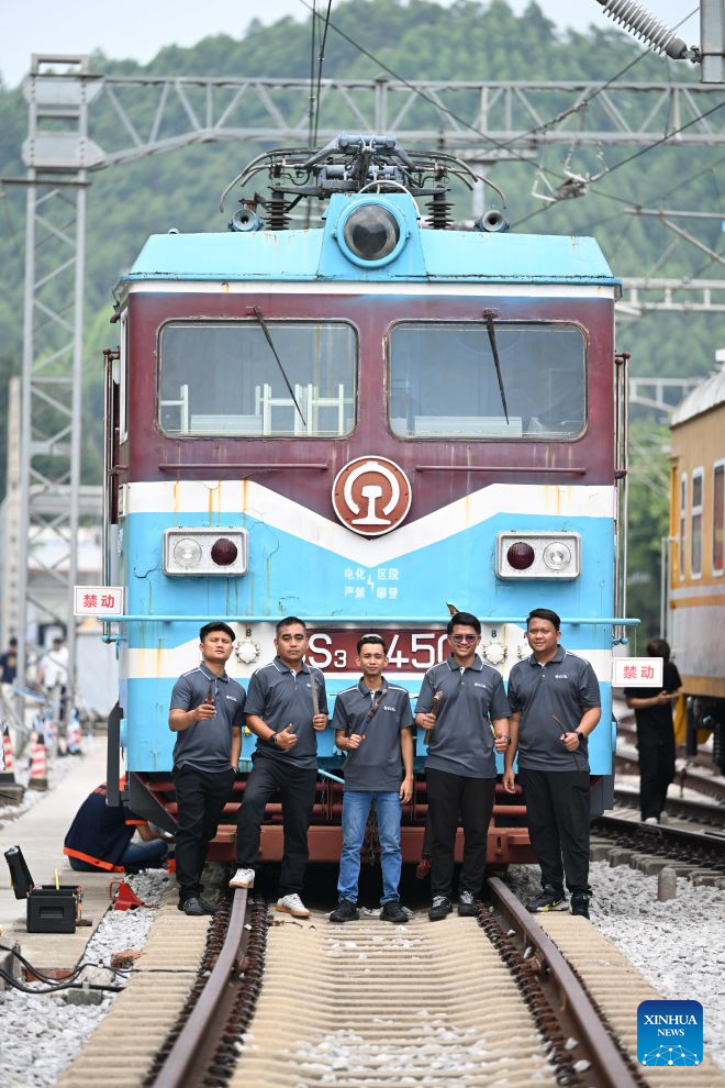 Trainees from Malaysia's East Coast Rail Link (ECRL) project pose for photos at the outdoor railway comprehensive training base of Liuzhou Railway Vocational Technical College in Liuzhou, south China's Guangxi Zhuang Autonomous Region, Sept. 15, 2026. (Xinhua/Huang Xiaobang)