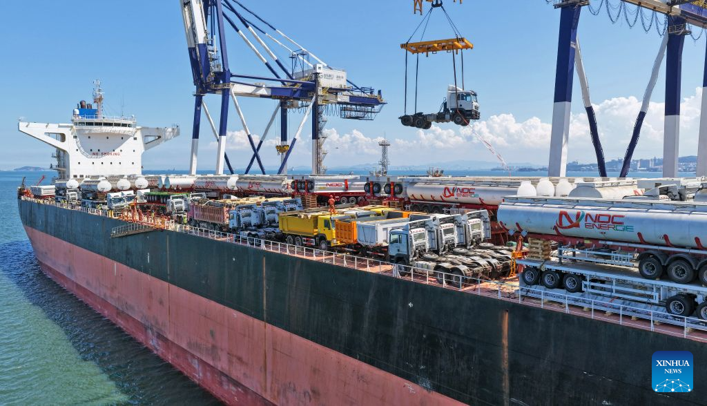 A drone photo taken on Aug. 16, 2026 shows China-produced trucks bound for Ghana being loaded onto a vessel at Yantai Port in east China's Shandong Province. Yantai Port's general cargo shipment volume to Africa has exceeded 6 million tonnes since the beginning of this year, a year-on-year increase of 66.1 percent. (Photo by Tang Ke/Xinhua)