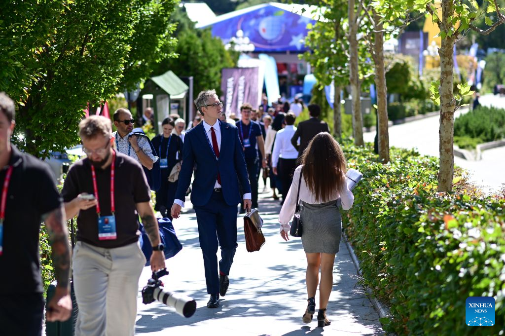Participants walk past an exhibition area during the 35th Economic Forum in Karpacz, Poland, on Sept. 8, 2026. The 35th Economic Forum is held from Sept. 8 to 10 in Karpacz, bringing together representatives from politics, business, academia and other fields. (Photo by Aleksy Witwicki/Xinhua)