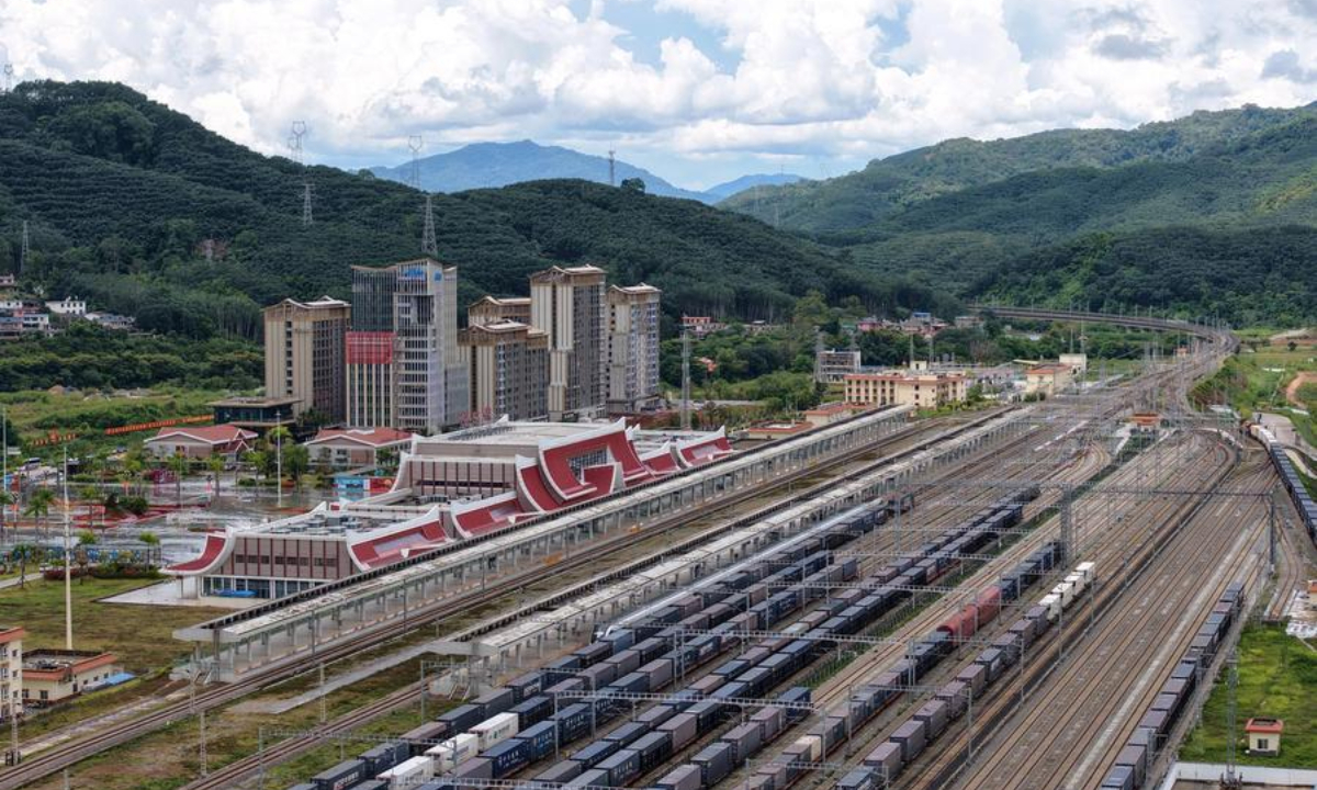An aerial drone photo taken on Sept. 21, 2025 shows freight trains running past the Mohan Railway Station of the China-Laos Railway in southwest China's Yunnan Province. (Xinhua/Xing Guangli)