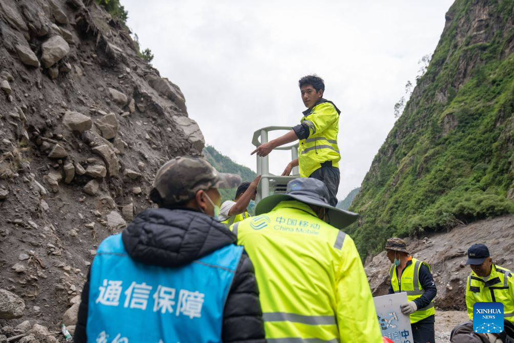 Communication support workers set up a 4G/5G base station at the mudslide-hit area in Gyirong County, southwest China's Xizang Autonomous Region, Aug. 30, 2026. A newly-built 4G/5G base station, approximately 900 meters from the mudslide-hit Gyirong Port in Gyirong County, was put into use on Sunday, ensuring more stable communication signals at the core rescue site. (Xinhua/Tenzing Nima Qadhup)