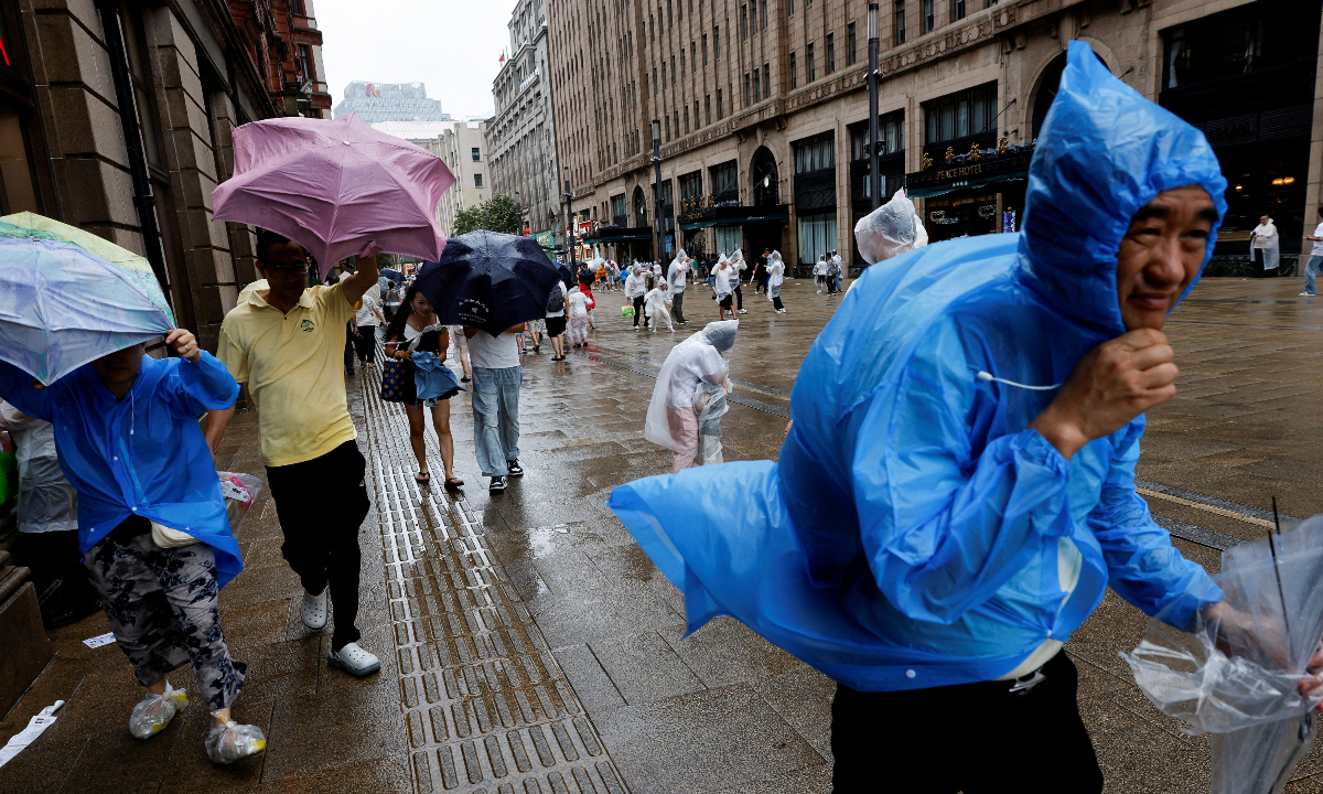 Residents in Shanghai braved strong winds and rain with umbrellas and raincoats on August 9, 2026, as Typhoon Dolphin, the year’s 13th typhoon, affected the city. Photo: IC