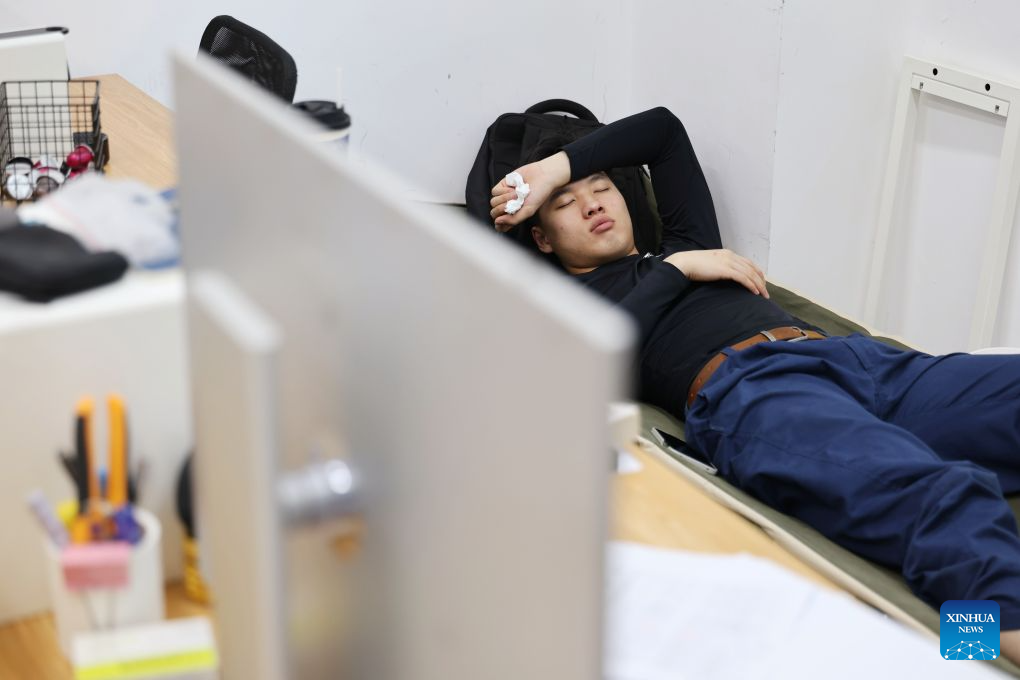 Liu Yuxuan takes a nap at a training base of Tianjin Electronic Information Technician College for the 48th WorldSkills Competition in Tianjin, north China, Sept. 11, 2026. (Xinhua/Li Ran)