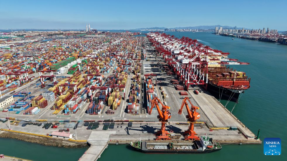 An aerial drone photo taken on Oct. 8, 2026 shows a view of Qingdao Port in Qingdao, east China's Shandong Province. As an international shipping hub in Northeast Asia, Qingdao Port has been expanding its shipping network, adding 16 foreign trade routes so far this year. The port now operates nearly 240 foreign trade routes, connecting over 700 ports in over 180 countries and regions. (Xinhua/Li Ziheng)