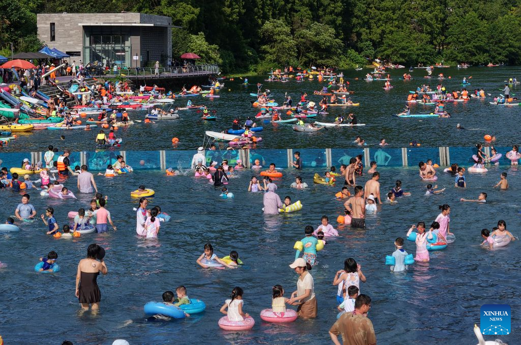 A drone photo taken on Aug. 2, 2026 shows people cooling off at a swimming pool in Jiande City, east China's Zhejiang Province. (Photo by Ning Wenwu/Xinhua)